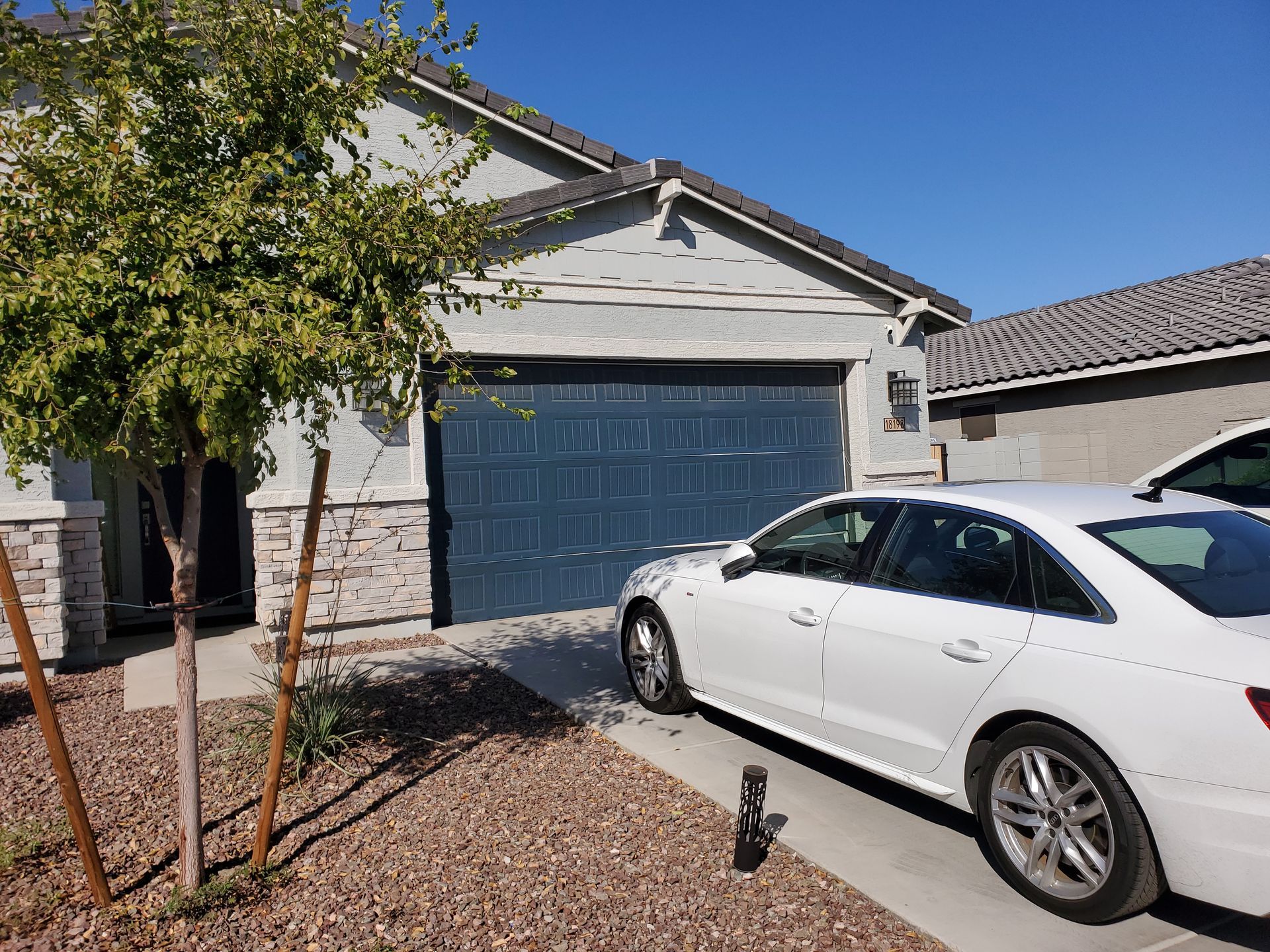 Before and after shots of a transformative garage door facelift in Gila Bend, AZ, by JCTZ experts.