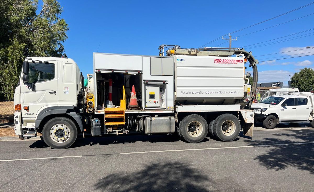 A white truck is parked on the side of the road.