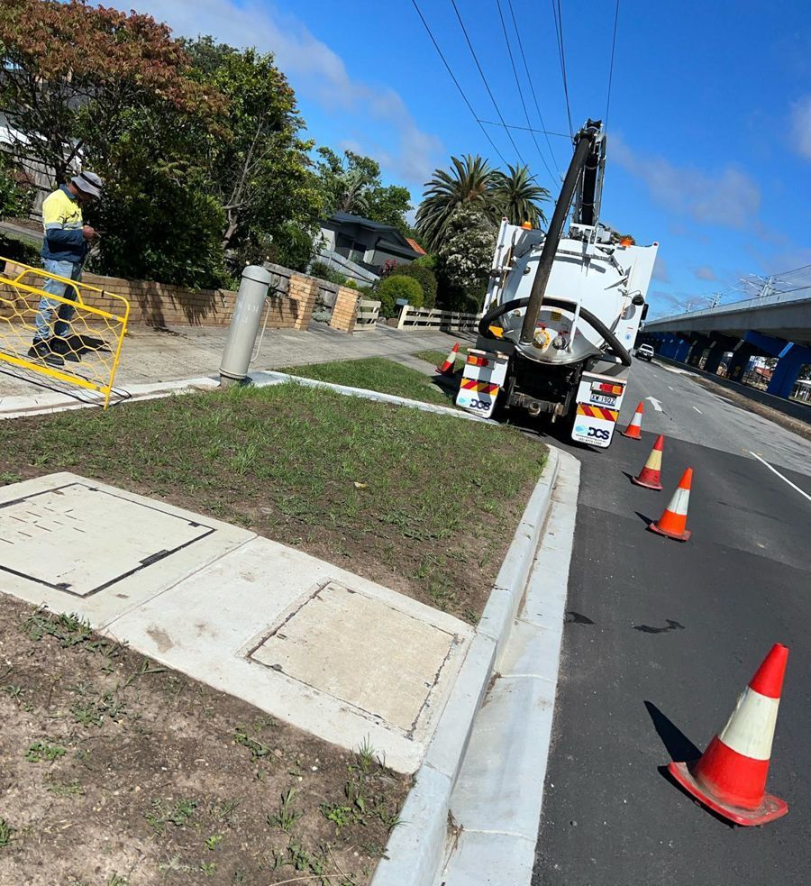 A blue and yellow truck is parked on the side of the road.