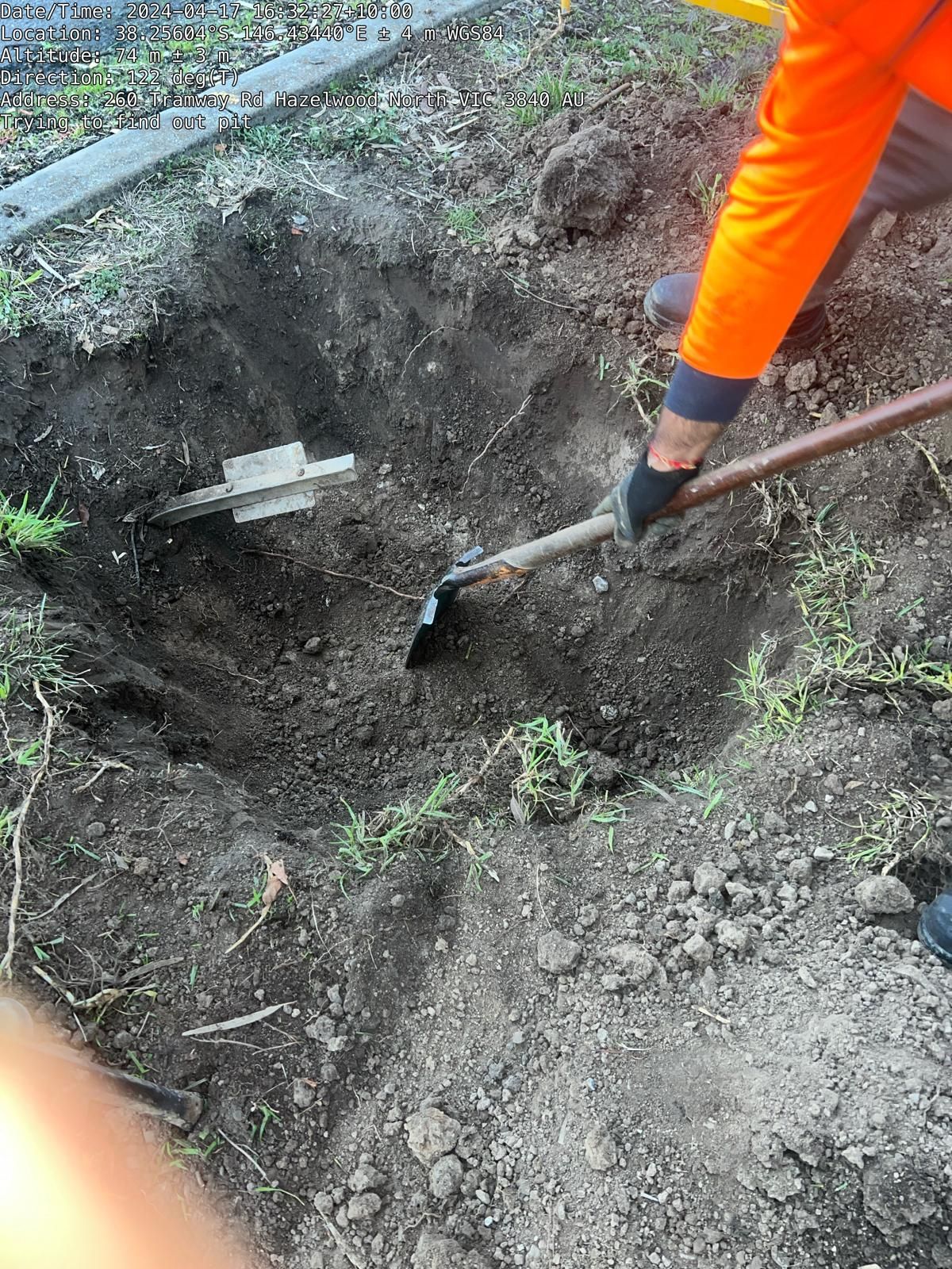 A person is digging a hole in the ground with a shovel.