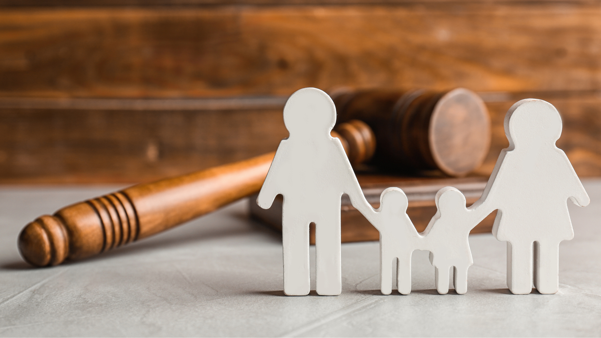 a wooden gavel with a family cut out of it .