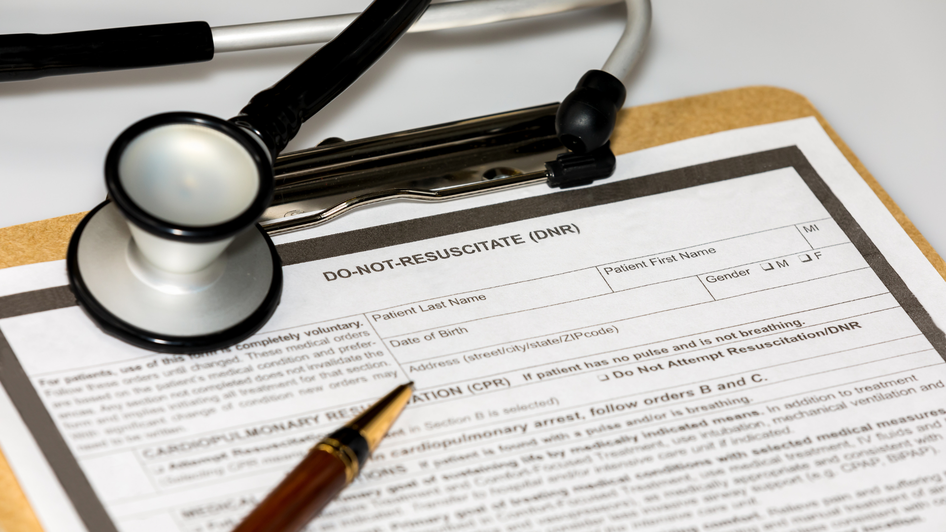 a stethoscope is sitting on top of a clipboard next to a pen .