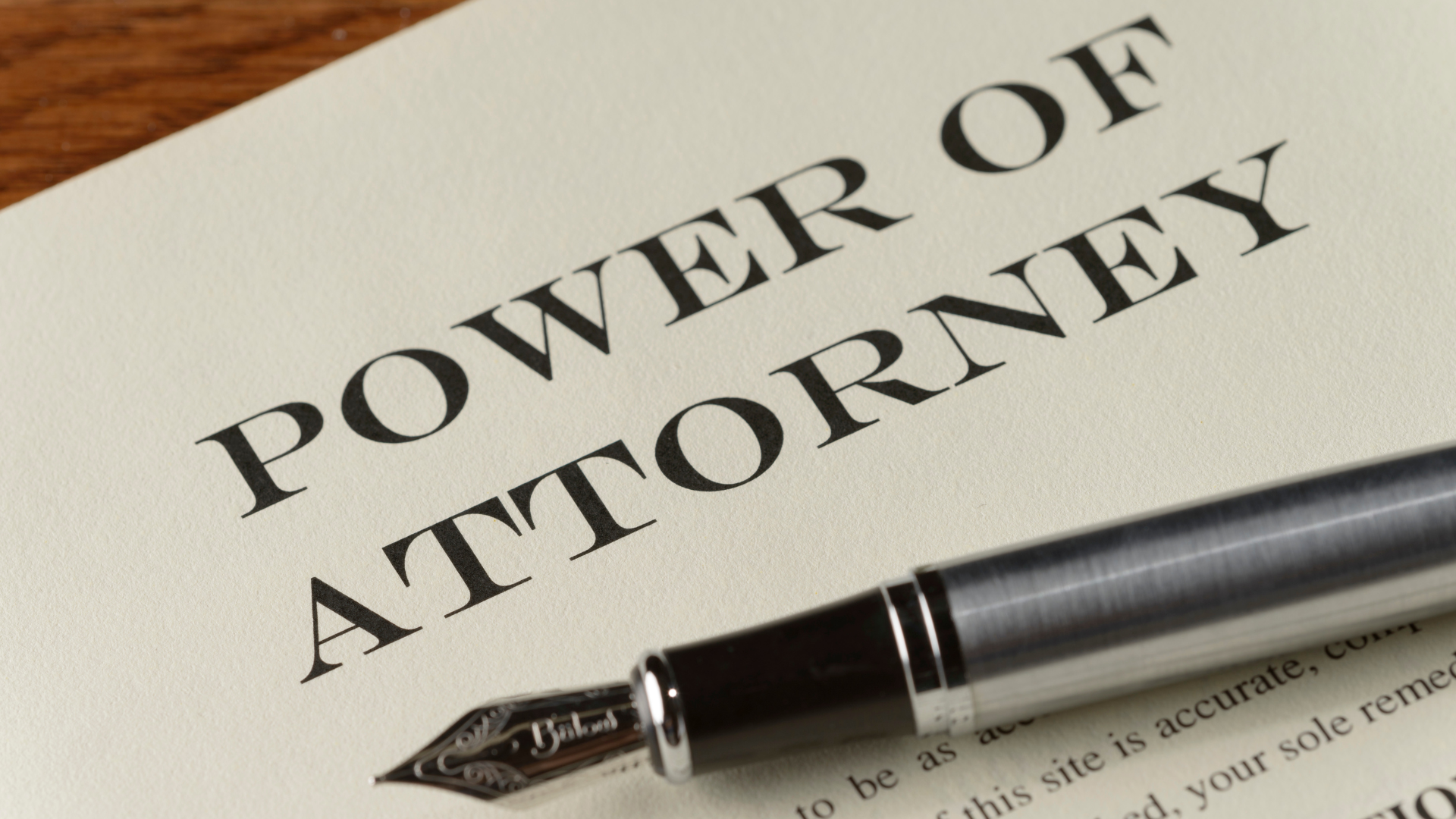 a pen is sitting on top of a power of attorney