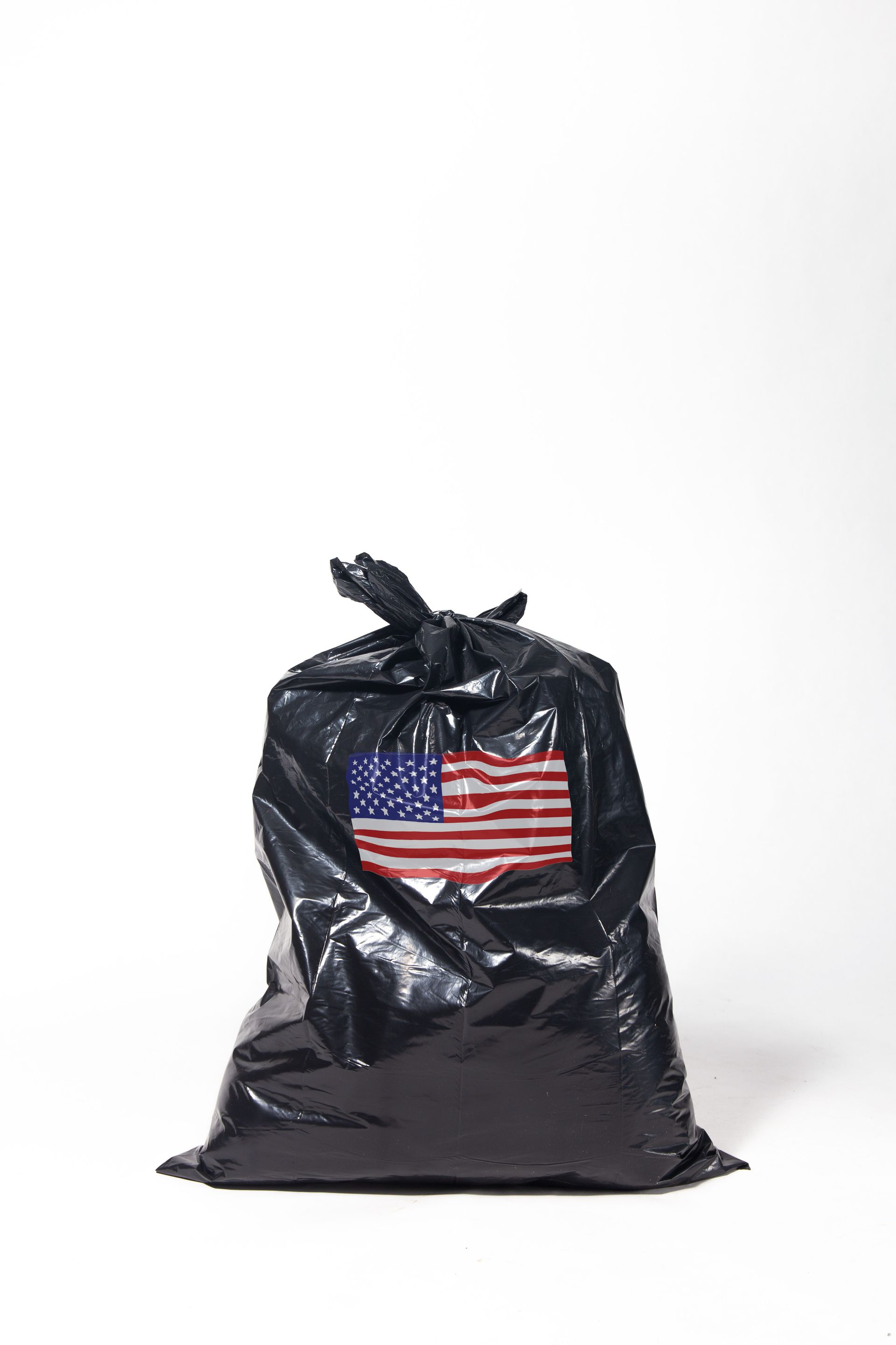 Black trash bag tied shut, with an American flag partially visible; art by Matt Remsbecher. 