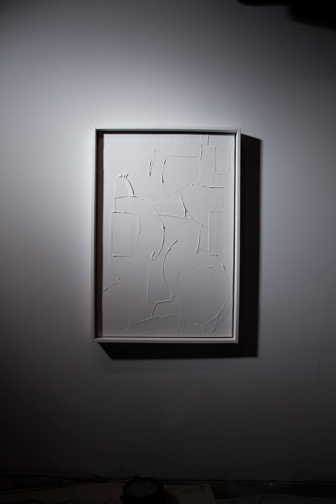 Textured White rectangular artwork, mounted on a white wall under directional lighting; art by Matt Remsbecher. 