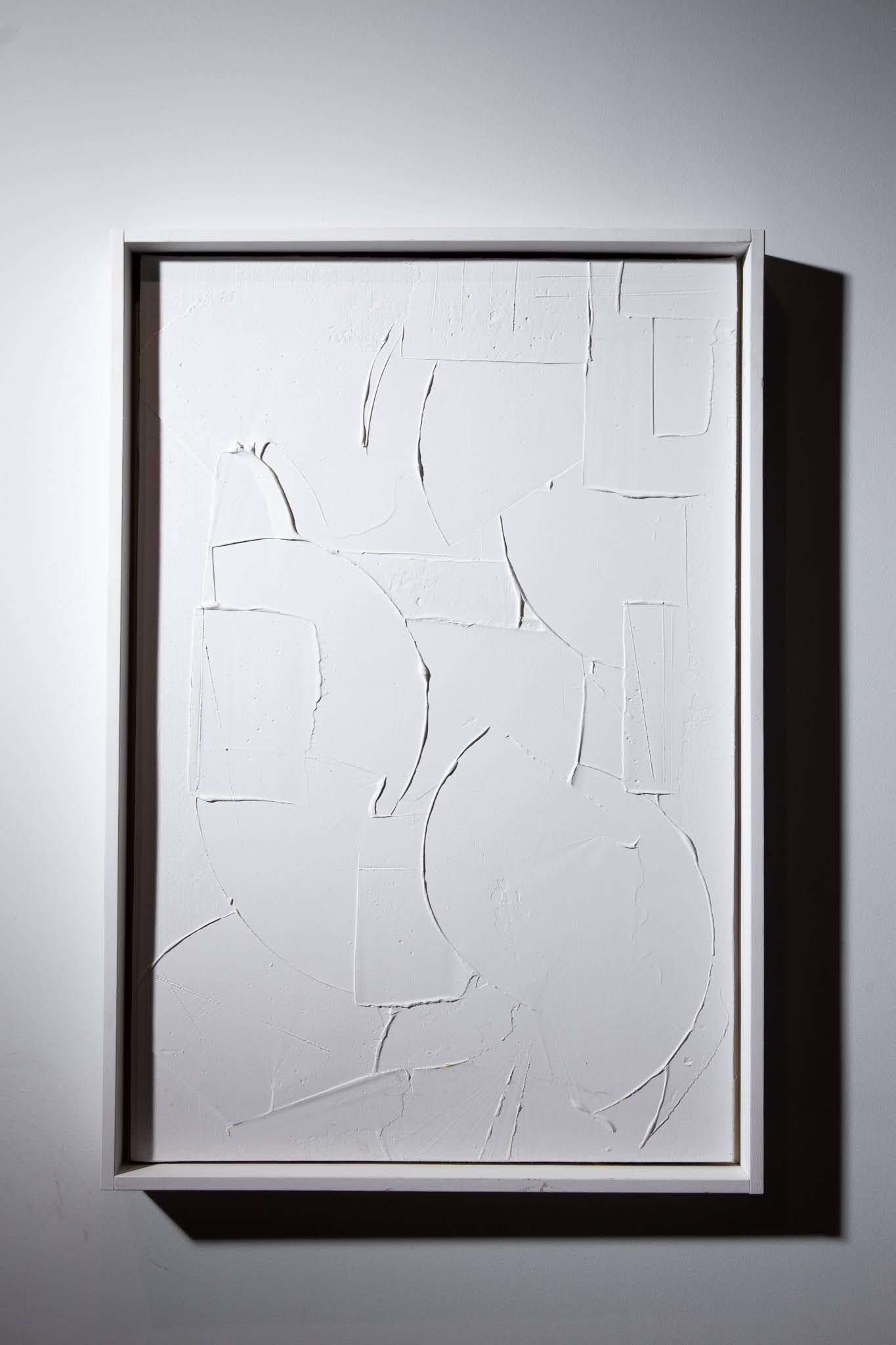 White abstract artwork in a white frame, displayed on a white wall; art by Matt Remsbecher. 