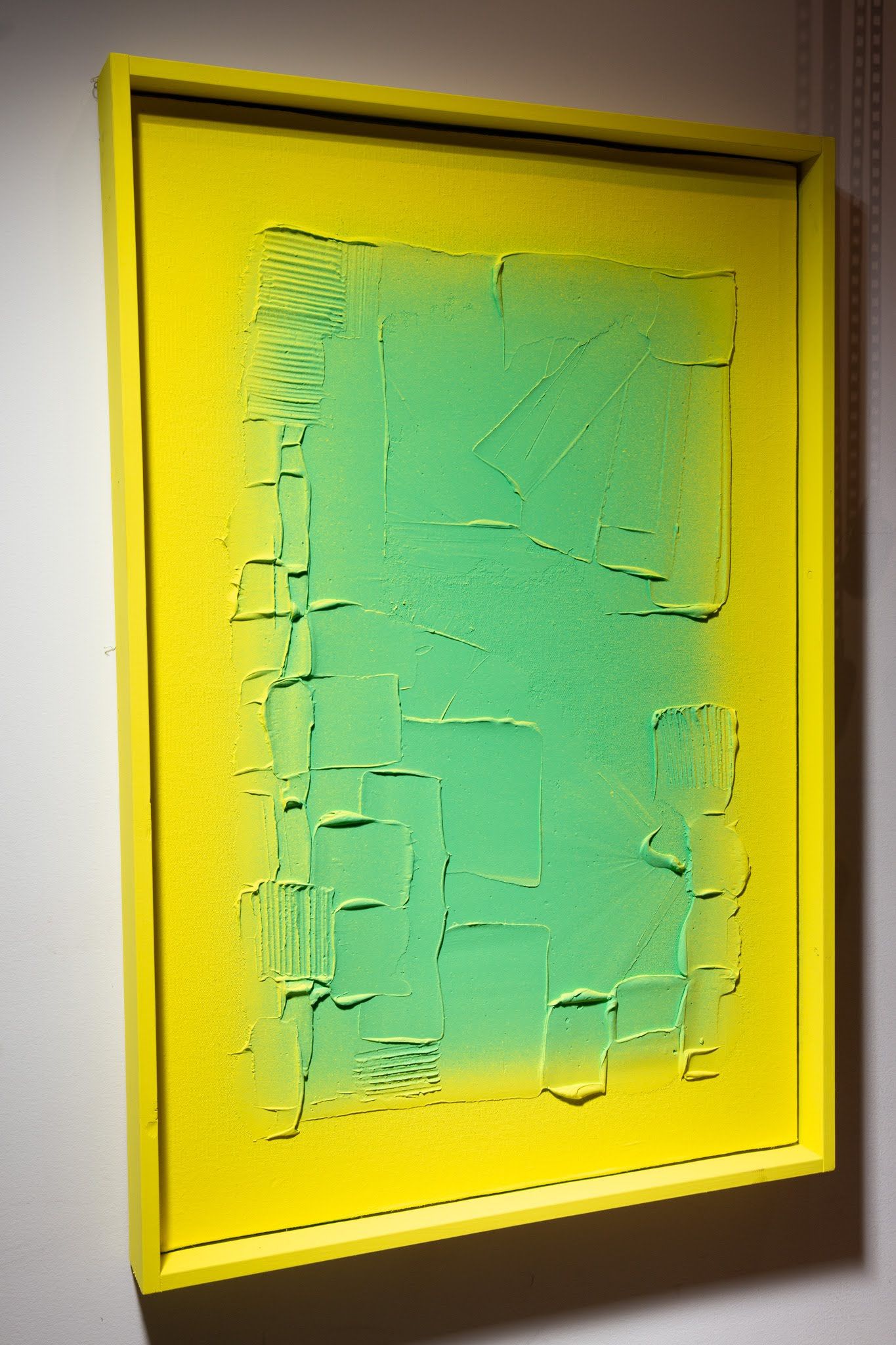 Yellow-framed abstract art with a green, textured central rectangle on a yellow background; art by Matt Remsbecher. 