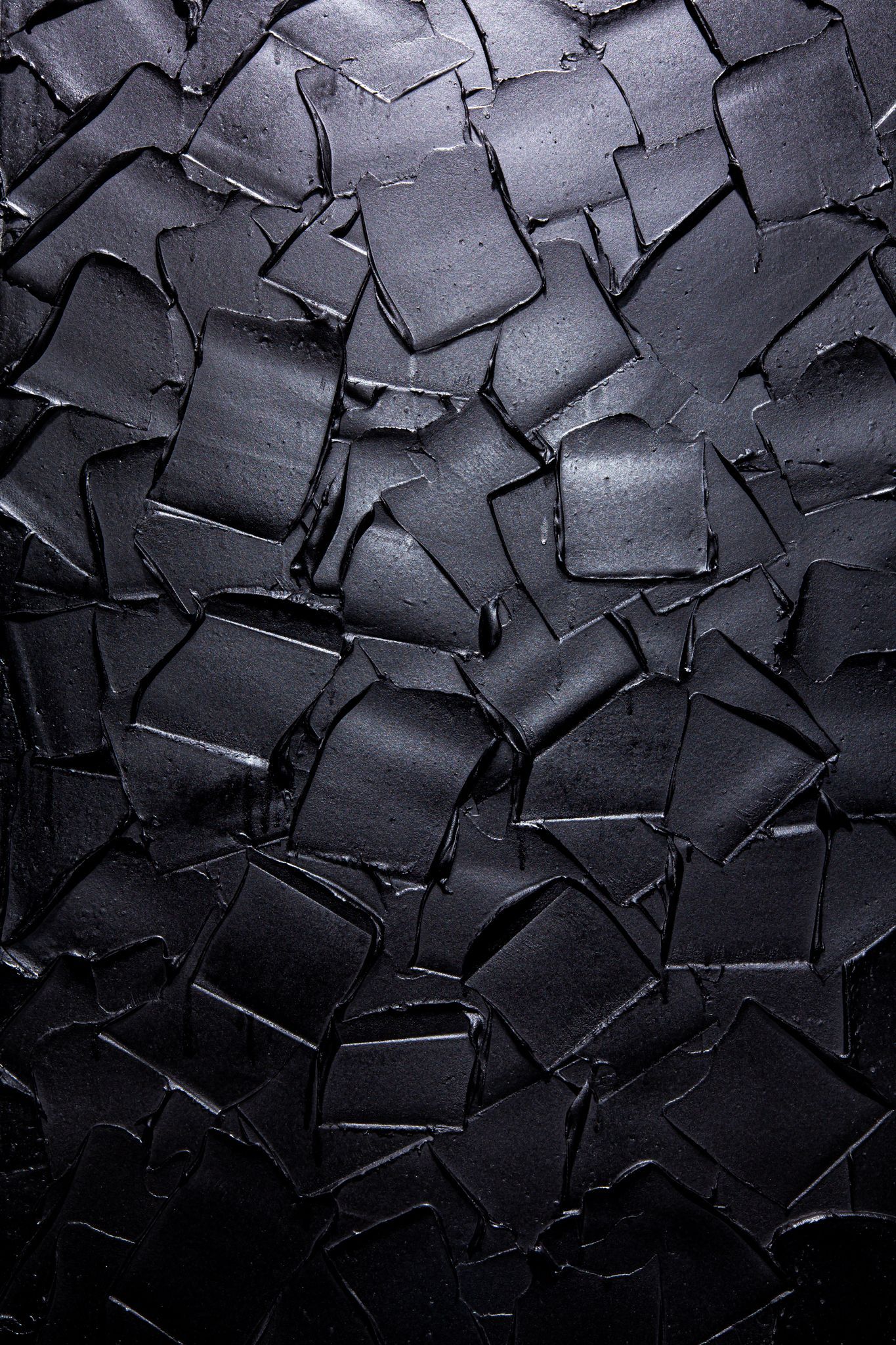 Dark textured abstract: black square shapes layered with a textured surface; art by Matt Remsbecher. 