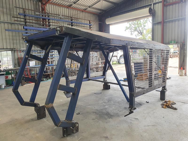 A blue metal structure is sitting inside of a building.