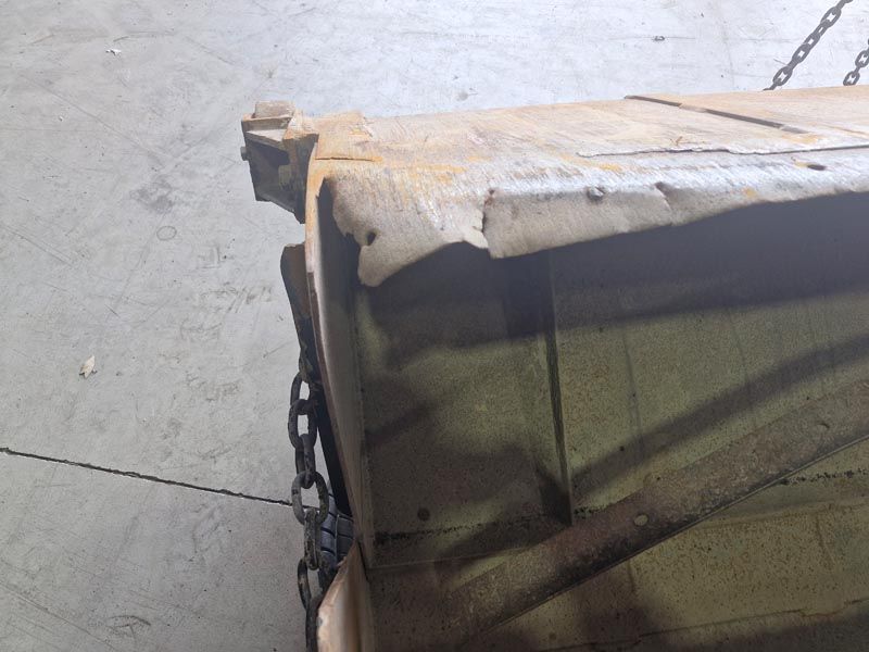 A piece of wood is chained to a concrete floor