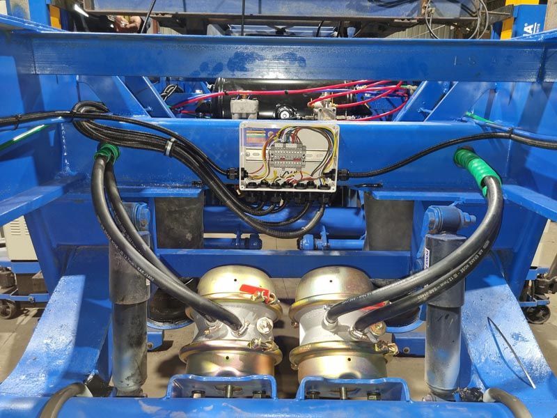 A blue machine with a bunch of wires coming out of it