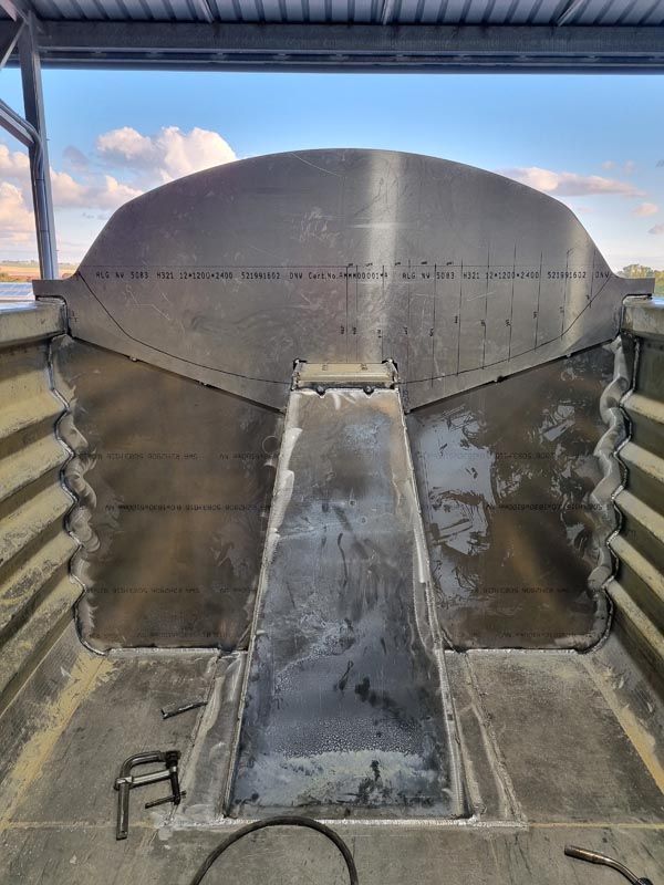 A large metal object is sitting on top of a concrete floor.