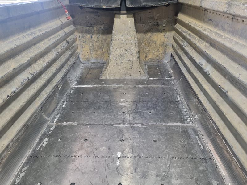 The inside of a metal container with a concrete floor.
