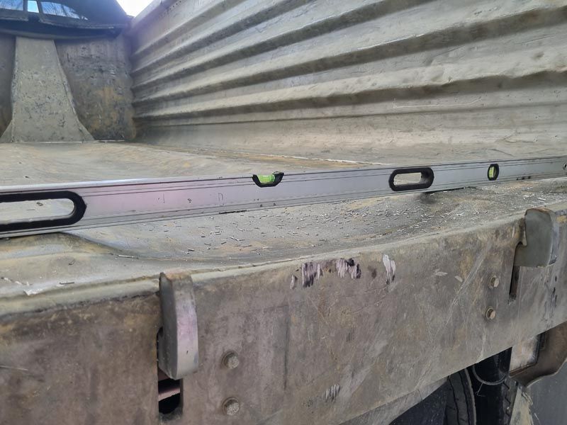 A level is sitting on the back of a truck.