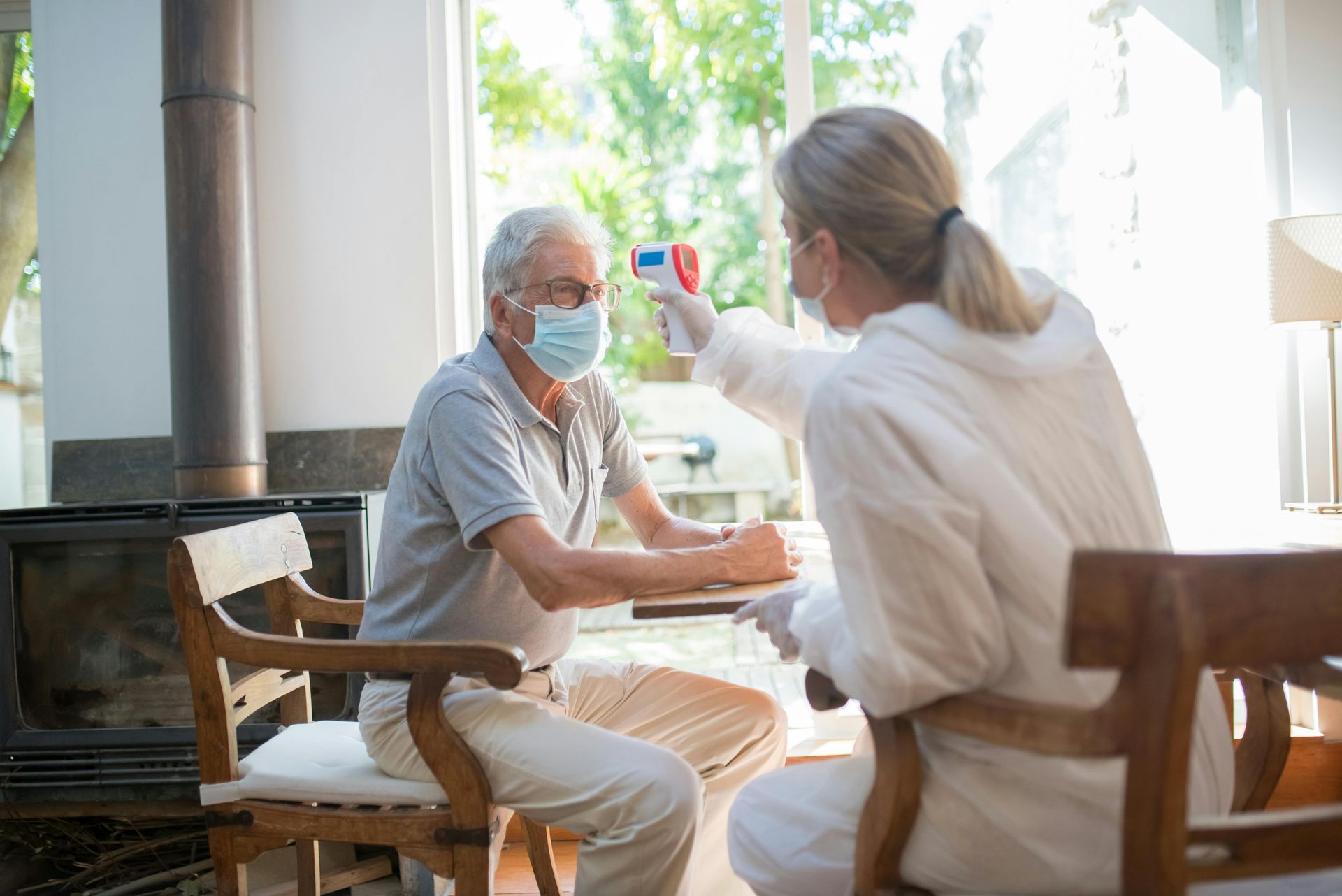 A woman is taking a man 's temperature with a thermometer.