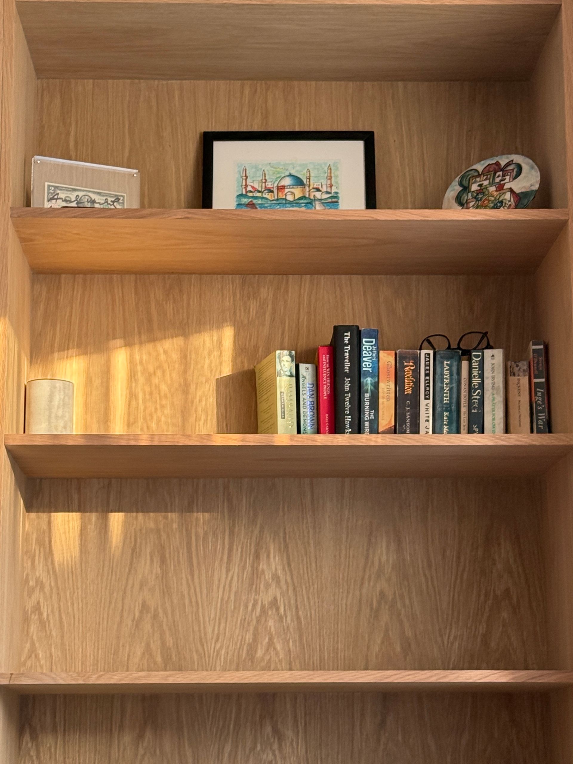 Wooden bookshelf with books and decorative items.
