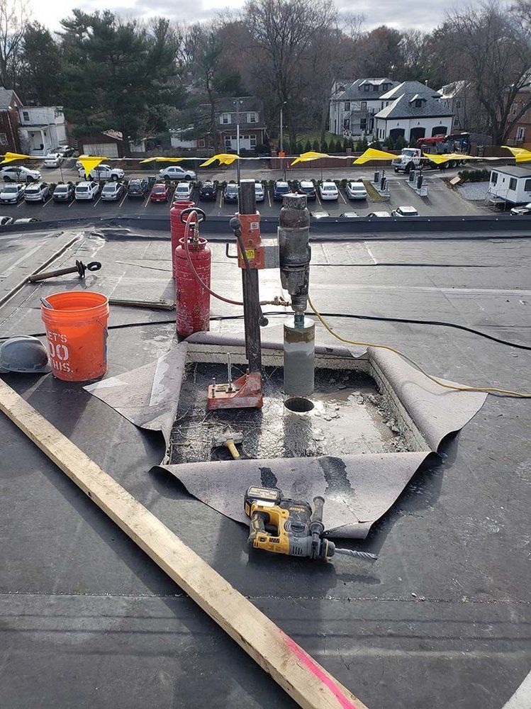 A drill is sitting on the roof of a building.