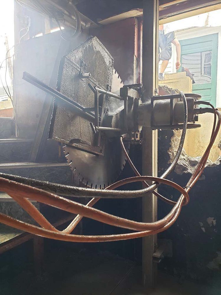 A circular saw is being used to cut a hole in a wall