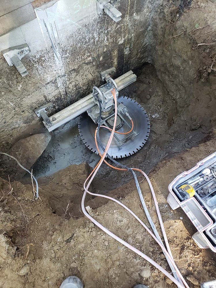 A concrete saw is cutting a hole in a wall.