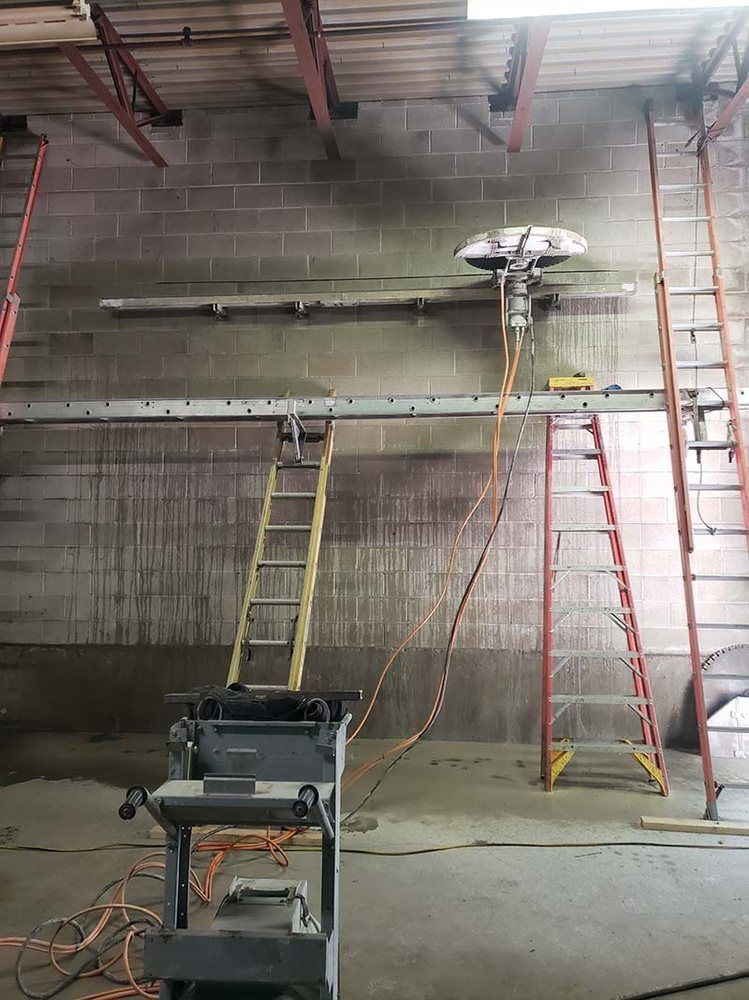 A ladder is hanging from the ceiling of a building.