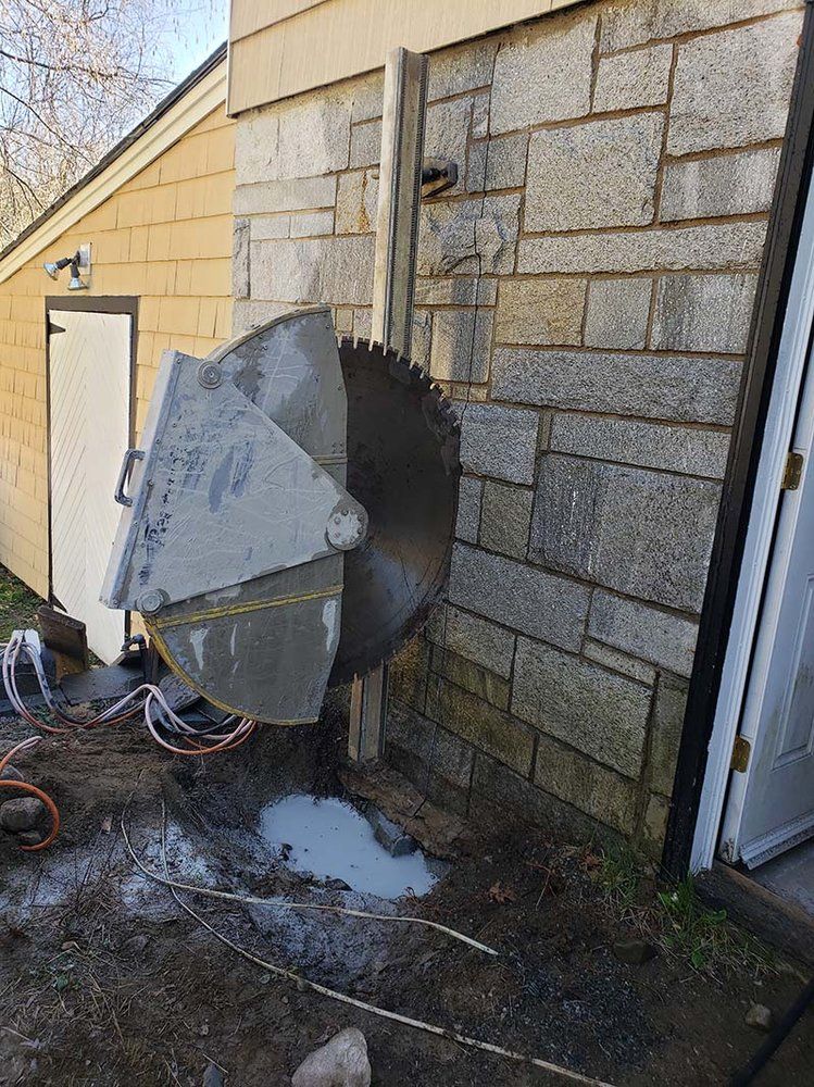 A large circular saw is cutting a hole in a brick wall.