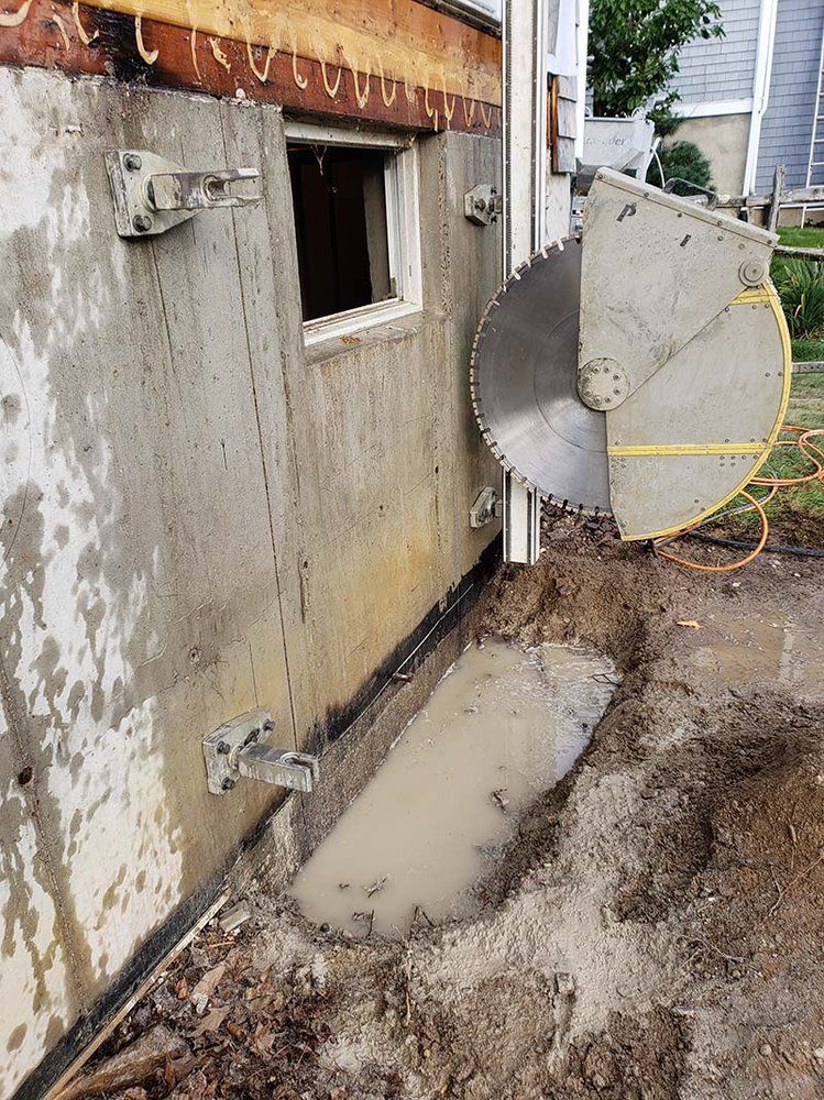 A concrete wall is being cut with a circular saw.