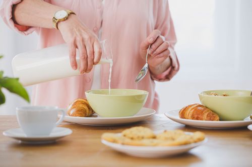 Person pouring milk into bowl