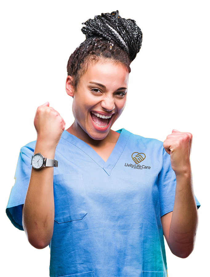 Livity Life Care Care Provider A Livity Life Care care provider in a blue scrub is holding her fist in the air and smiling.