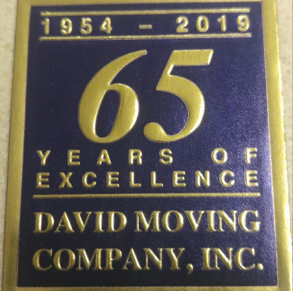 David Moving Company, Inc. 65-year anniversary logo. Blue background with gold text. Dates 1954-2019.