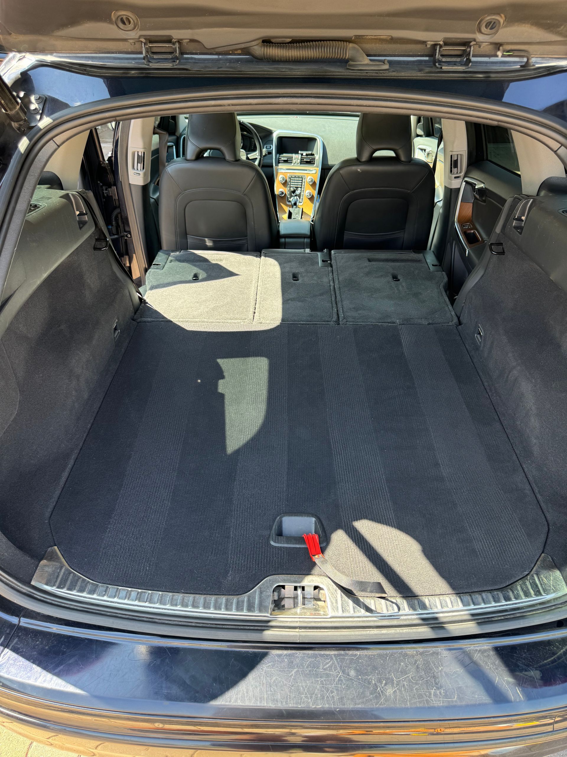 The back of a car with the trunk open and the seats folded down.