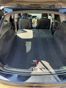 The back of a car with the trunk open and the seats folded down.