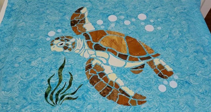 A painting of a sea turtle on a blue background