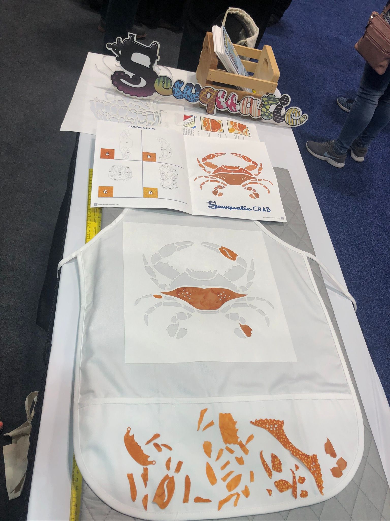 A white apron with a picture of a crab on it