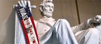 A statue of abraham lincoln holding an american flag