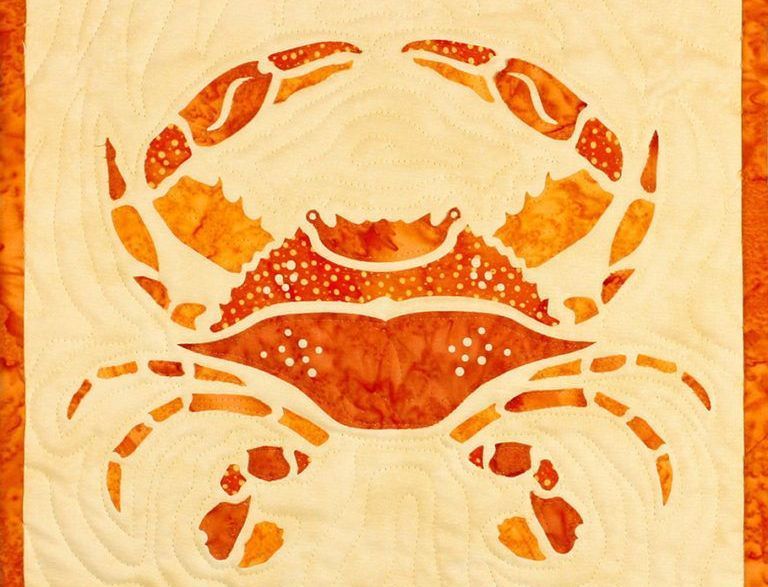 A crab is painted on a piece of fabric