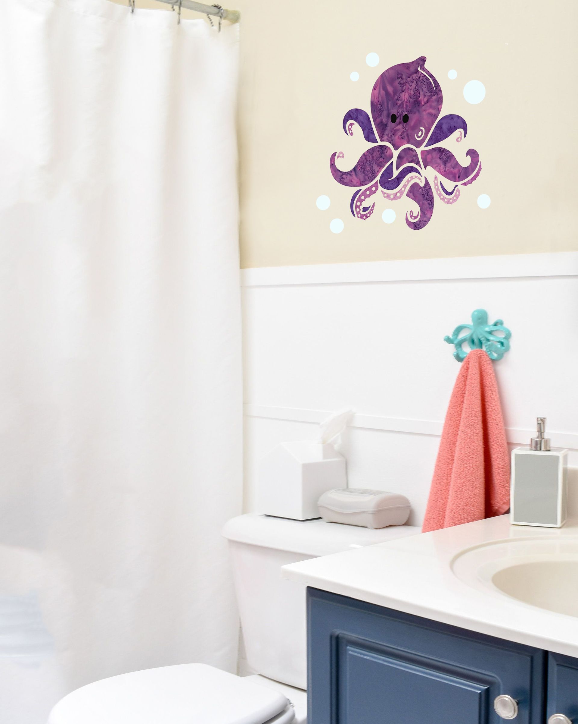 A bathroom with a purple octopus on the wall