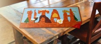 A wooden table with a sign on it that says utah.