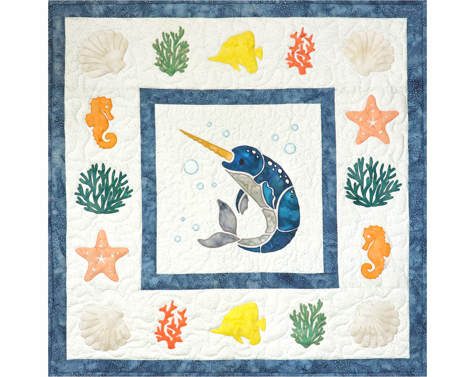 A quilt with a narwhal and sea creatures on it