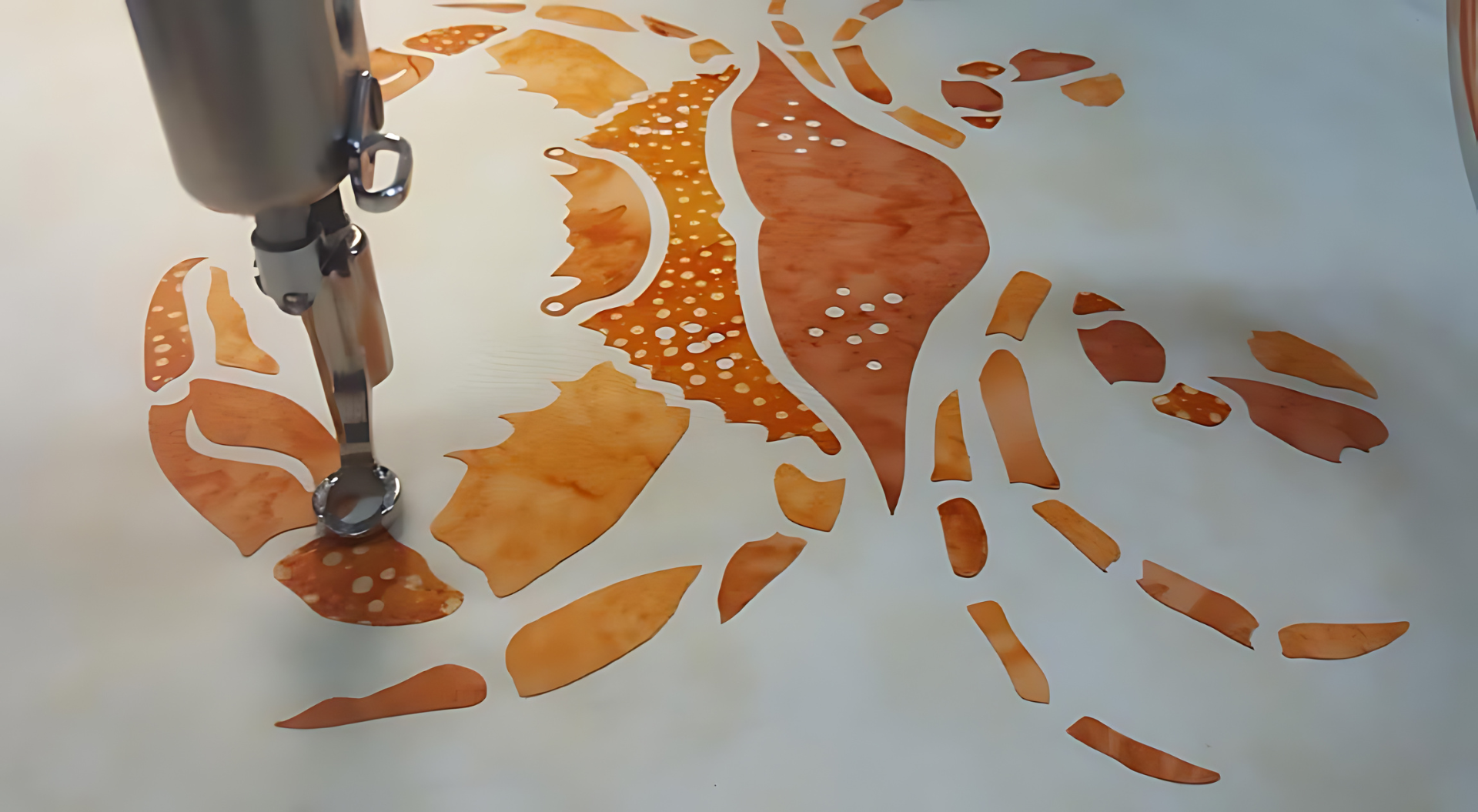 A sewing machine is making a crab pattern on a piece of paper