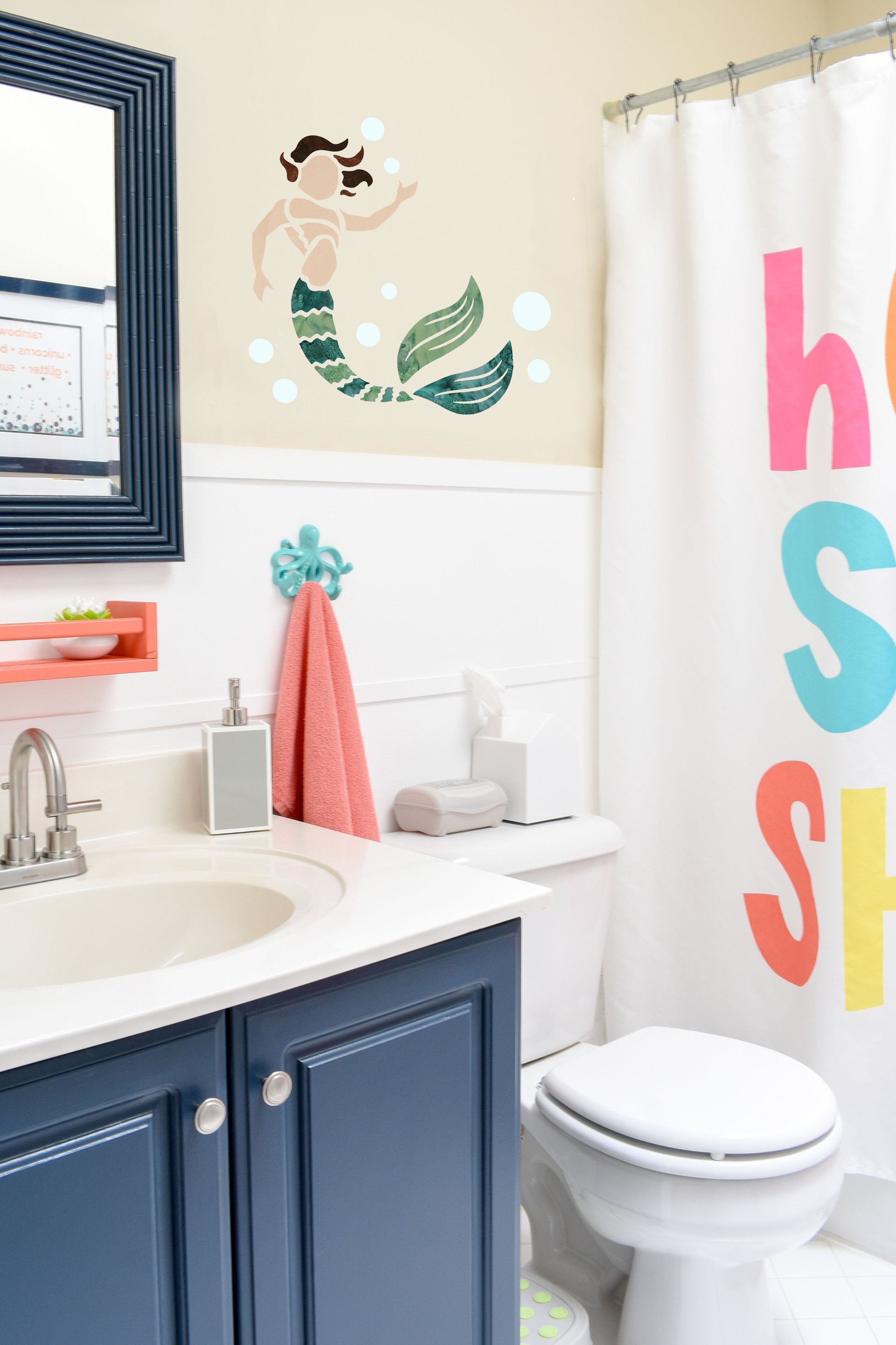 A bathroom with a sink , toilet , mirror and shower curtain.
