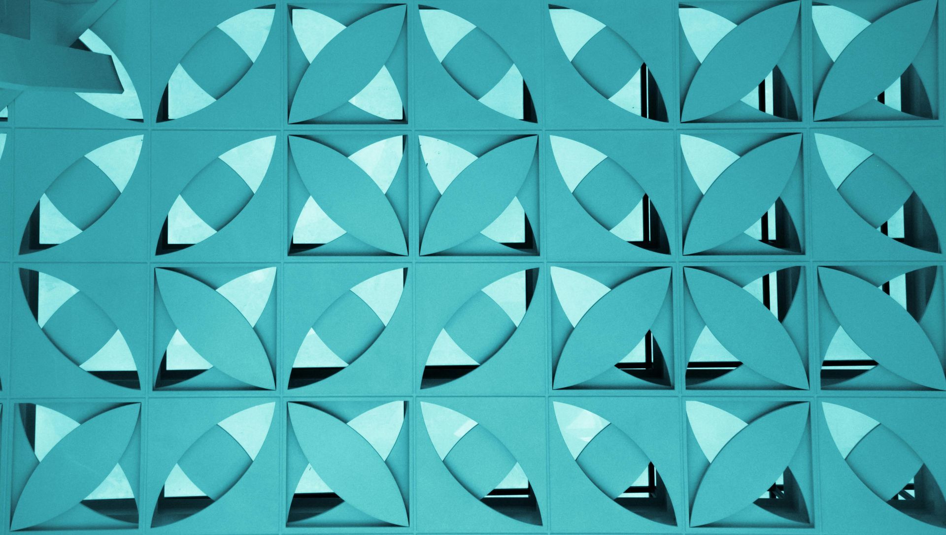 A blue wall with a geometric pattern on it