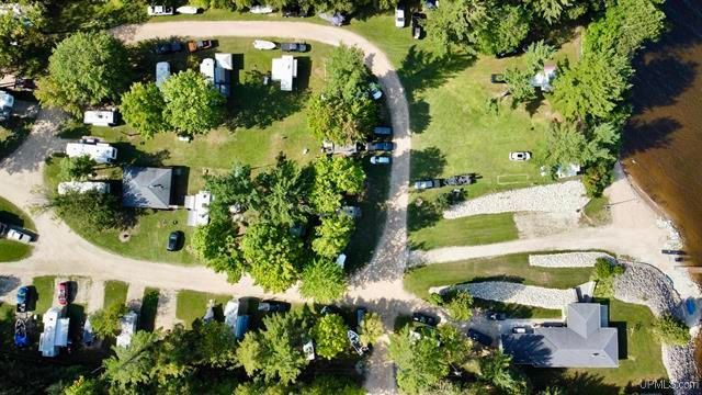 an aerial view of a campground with a lake in the background .