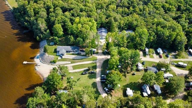an aerial view of a campground surrounded by trees and a lake .