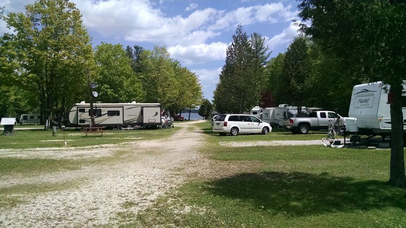 a lot of rvs are parked in a campground .