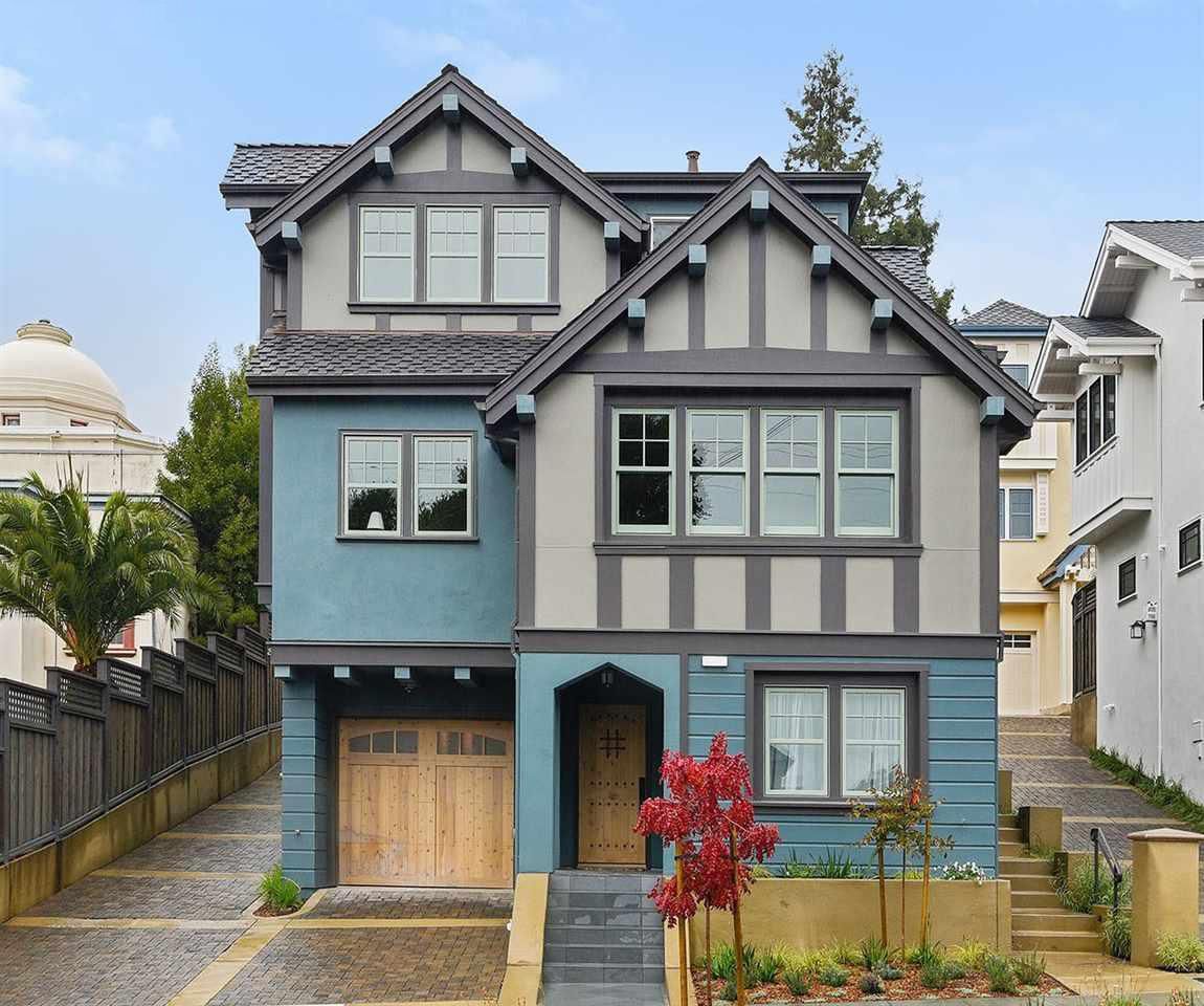 A blue and gray house with a wooden garage door