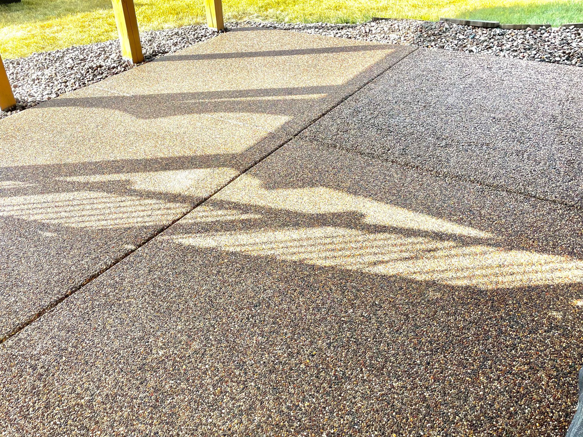 A close up of a concrete patio with a shadow on it.