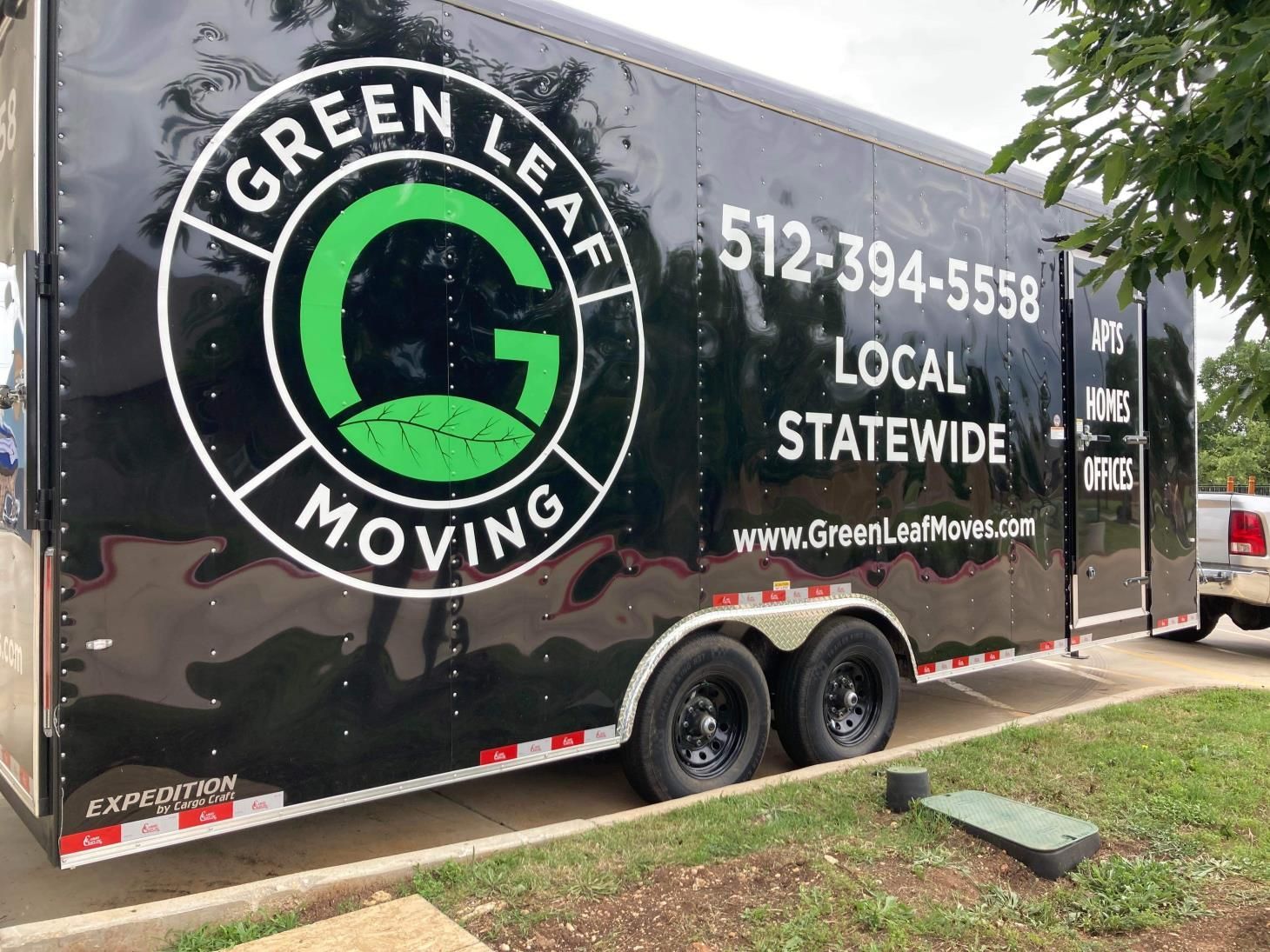 Black trailer for green leaf moving