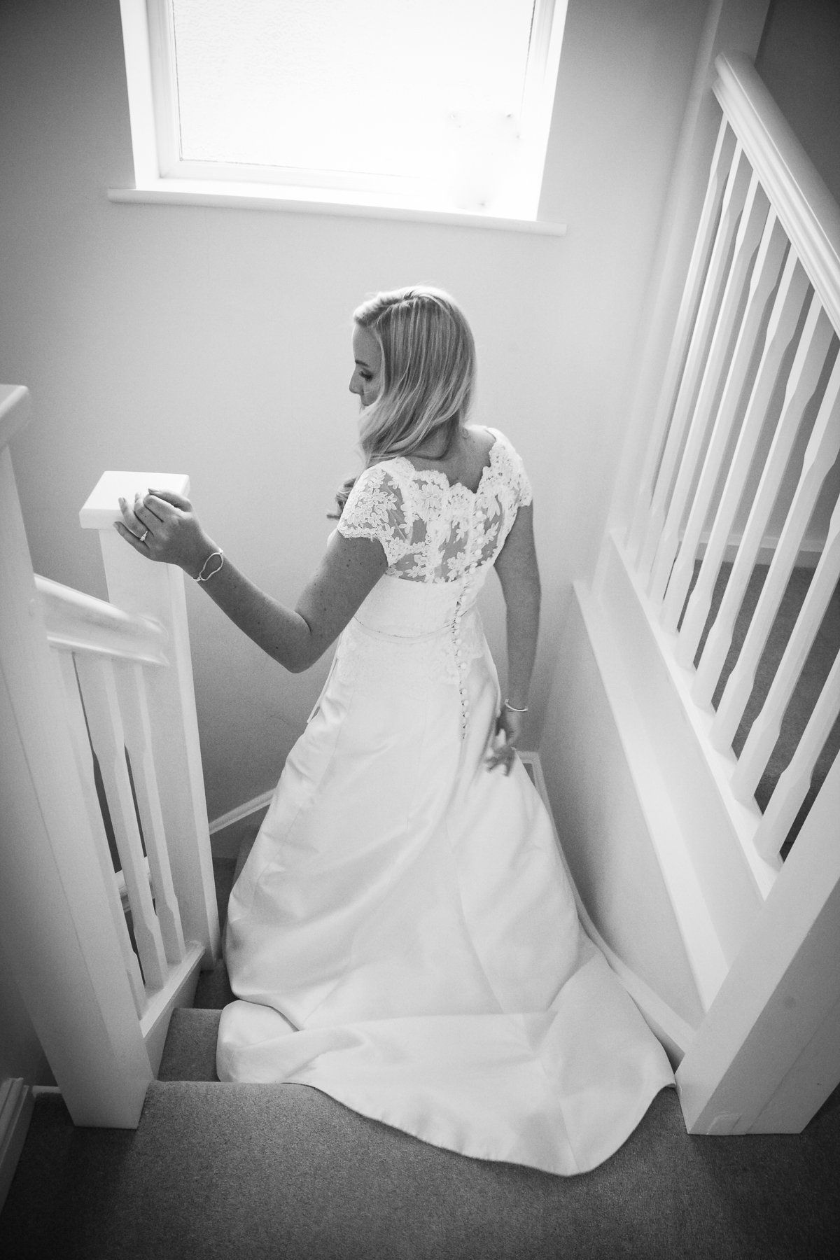 bride on stairs black and white photo