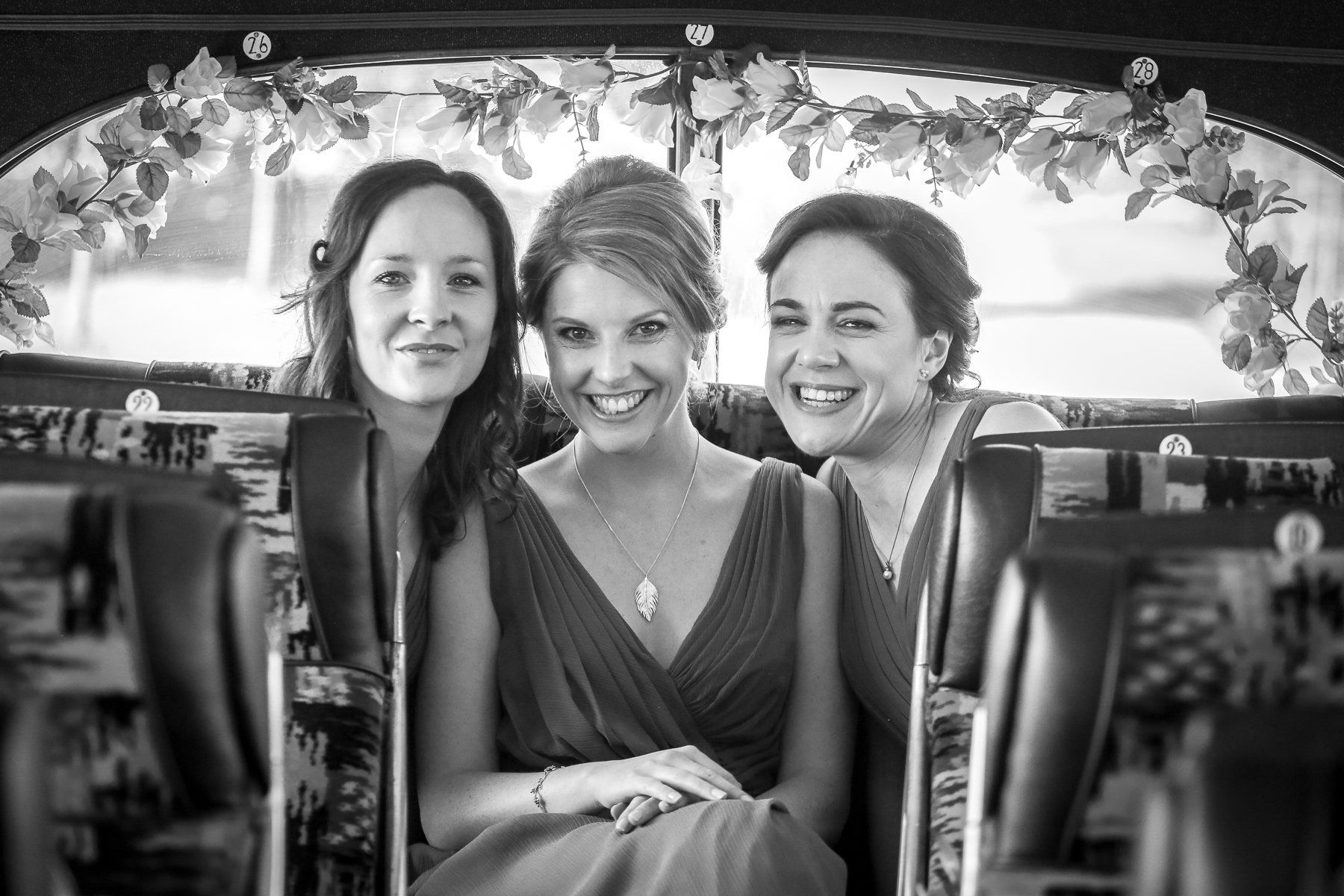 bridesmaids on bus at stone barn
