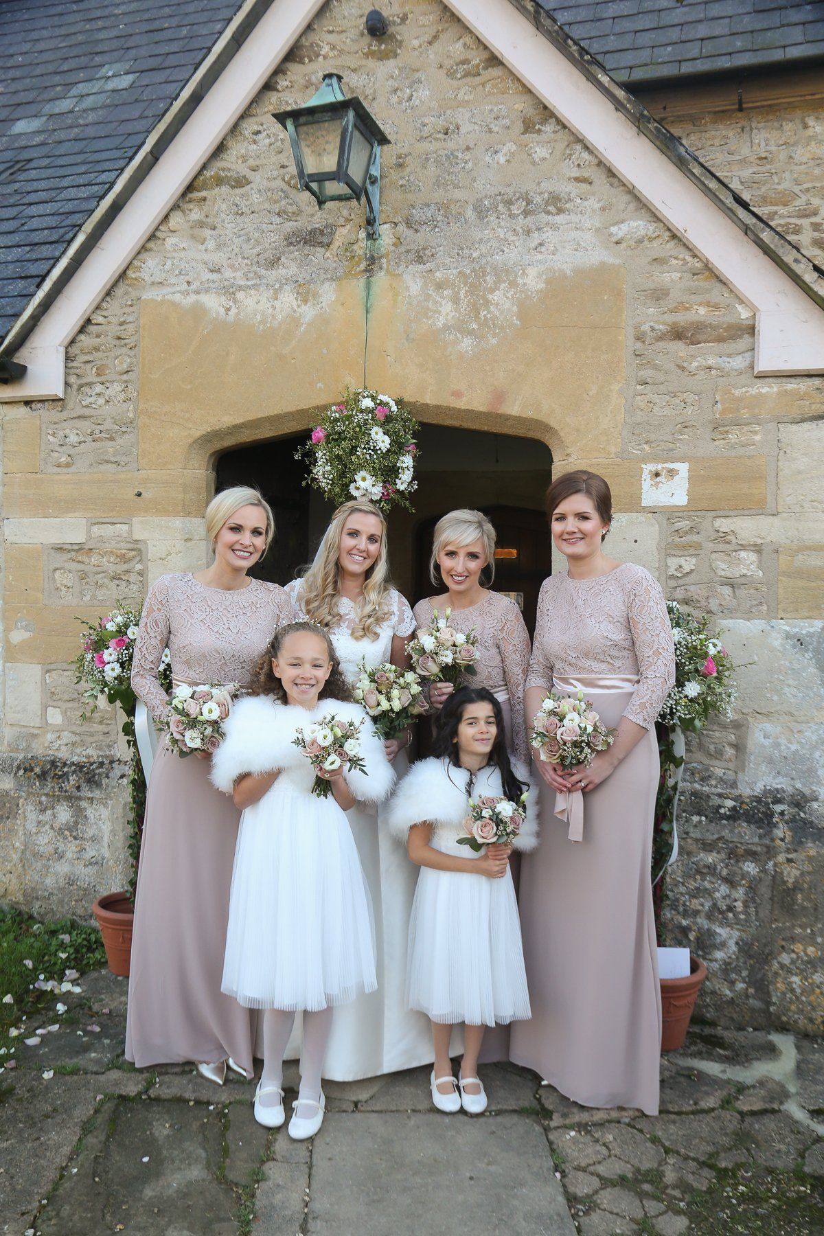 bride with bridesmaids and flower girls
